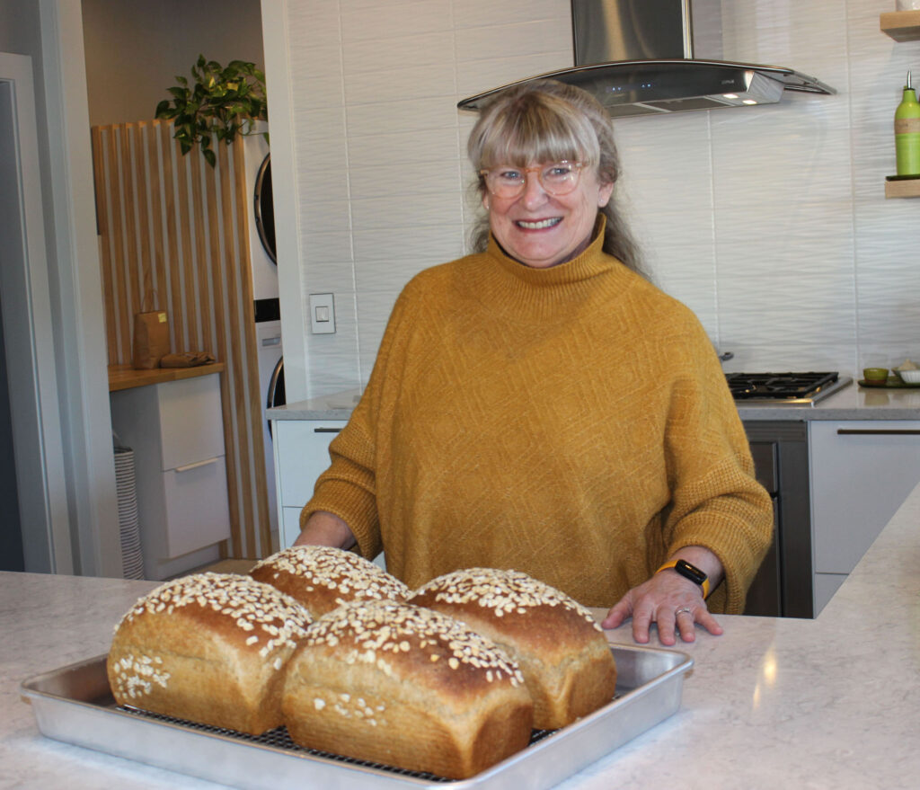 Nancy Leson with four loaves fresh out of the oven.