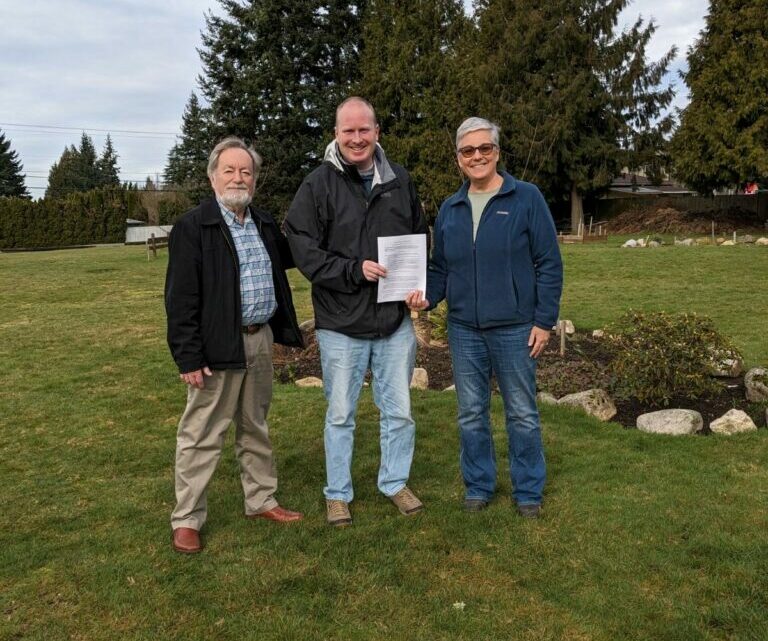 L-R Edmonds Food Bank Board Chair Pat Shields, Edmonds Lutheran Pastor Tim Oleson and Food Bank Executive Director Casey Davis with the memorandum of understanding signed this week.